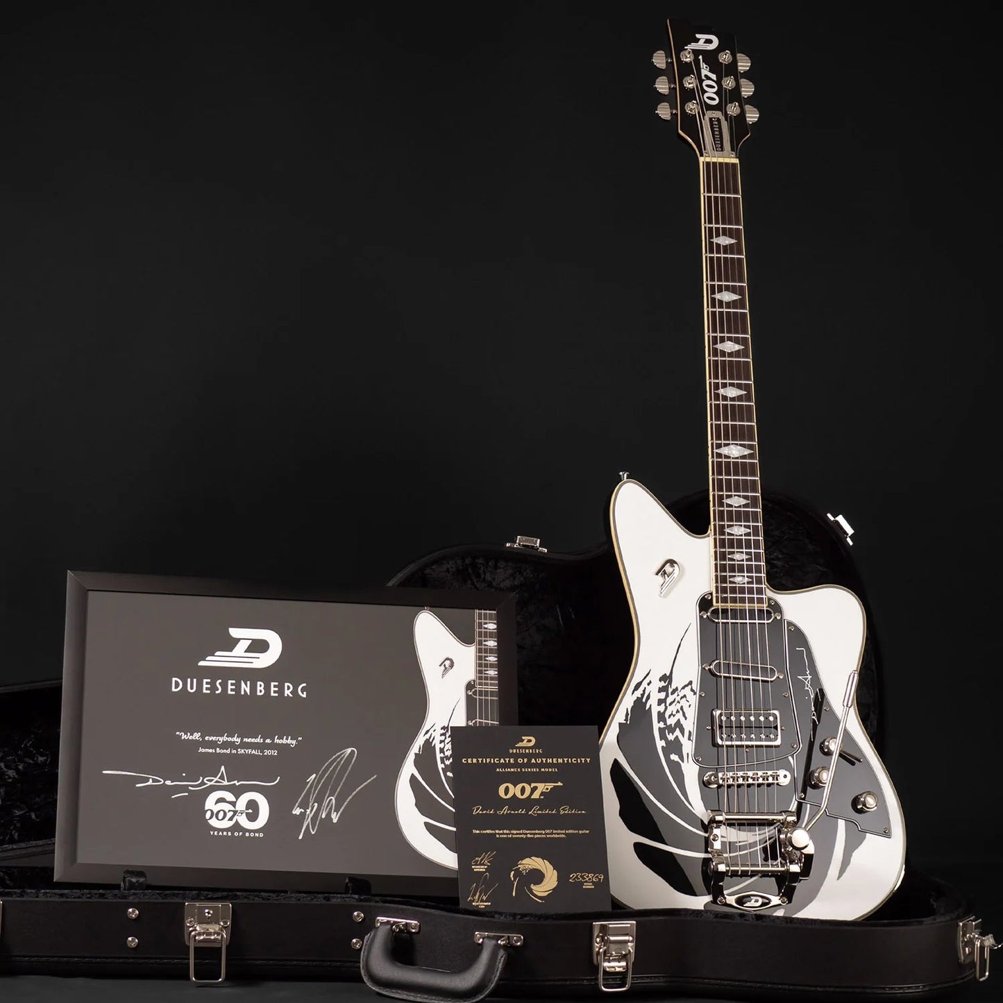 All of the case candy included with the Duesenberg Alliance Series James Bond 007 Alliance Electric Guitar. Case, framed and autographed picture, COA, picks and guitar.